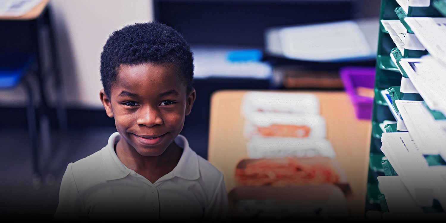Smiling student in a classroom.