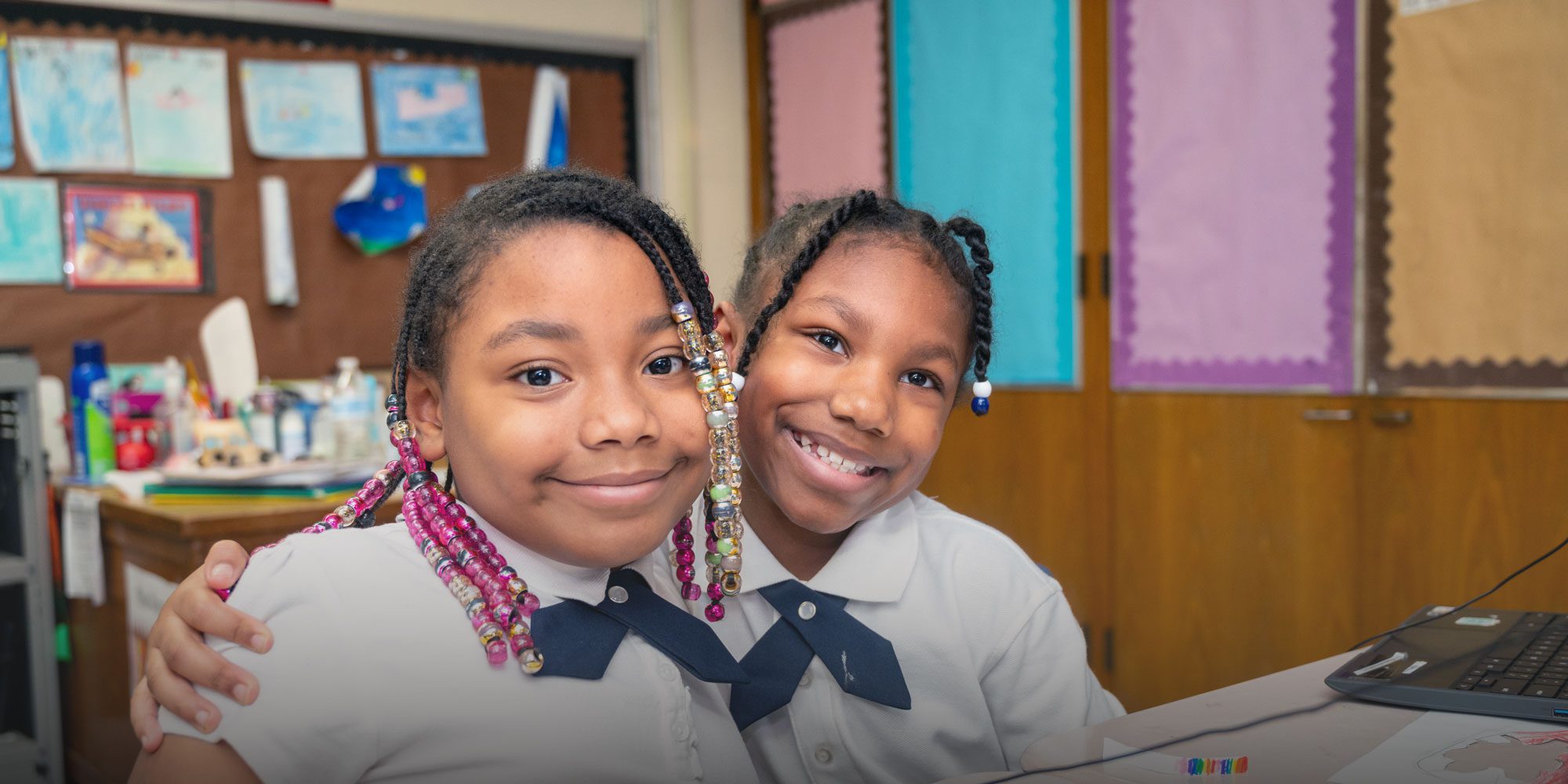 Smiling students sitting at desk
